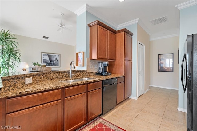 kitchen with dark stone counters, ceiling fan, sink, black dishwasher, and fridge