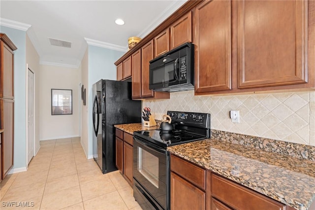 kitchen featuring decorative backsplash, dark stone counters, crown molding, black appliances, and light tile patterned floors