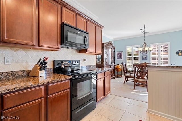 kitchen featuring hanging light fixtures, an inviting chandelier, dark stone counters, black appliances, and ornamental molding