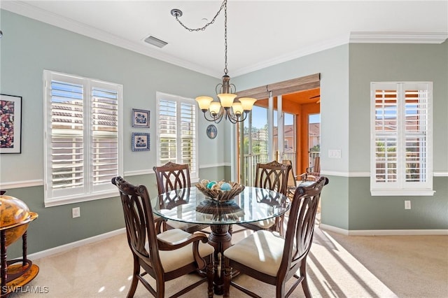 carpeted dining area featuring ornamental molding and a chandelier