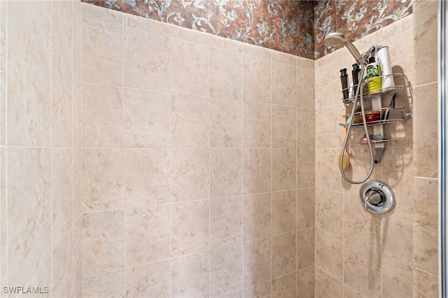 interior details featuring a tile shower