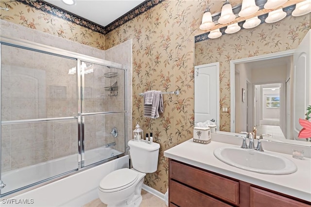 full bathroom with combined bath / shower with glass door, vanity, and toilet