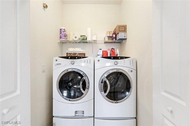 clothes washing area with separate washer and dryer