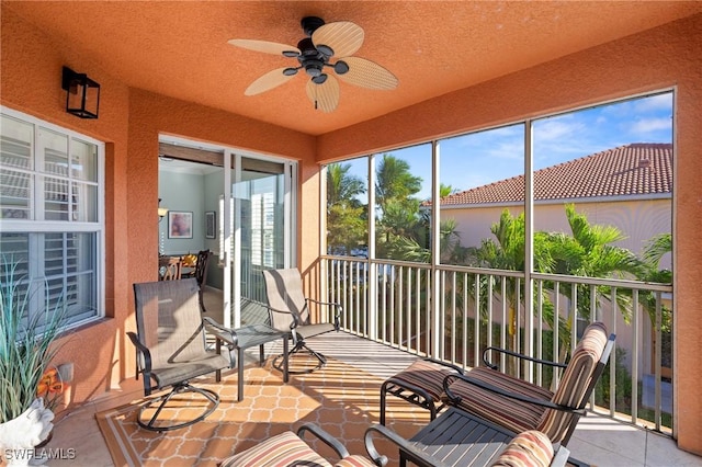 sunroom featuring ceiling fan