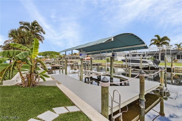 dock area featuring a yard and a water view