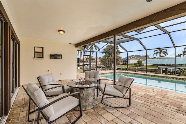 view of patio / terrace with a lanai and a fire pit