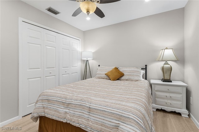 bedroom with ceiling fan, a closet, and light wood-type flooring