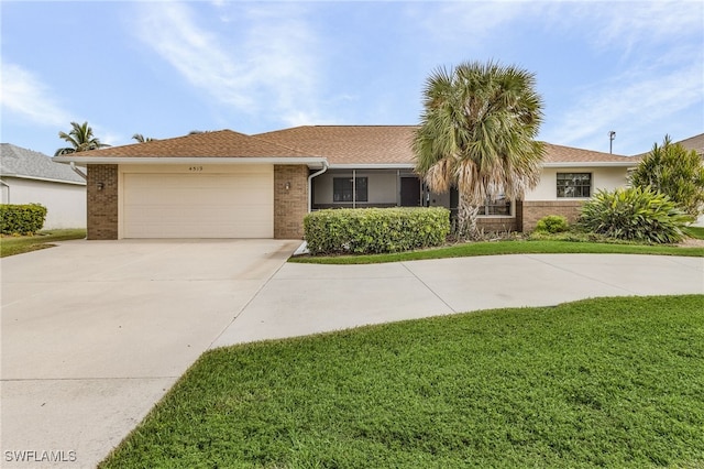 ranch-style home with a front lawn and a garage