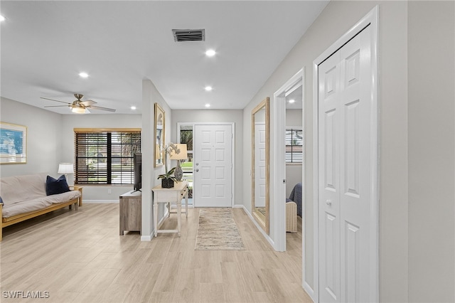 entryway with ceiling fan and light hardwood / wood-style floors