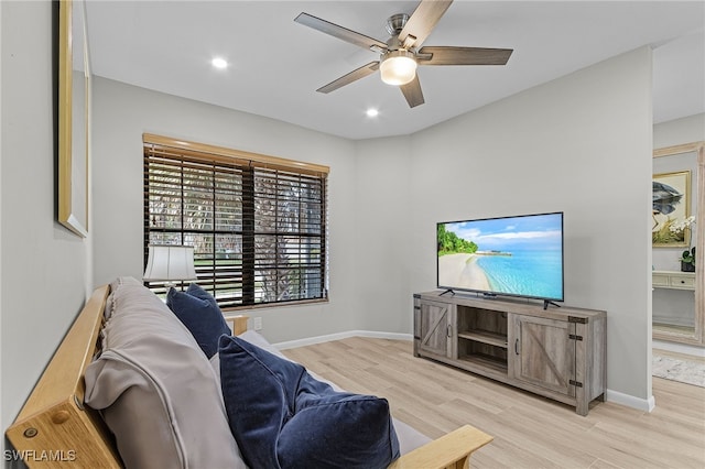 living room featuring light wood-type flooring and ceiling fan