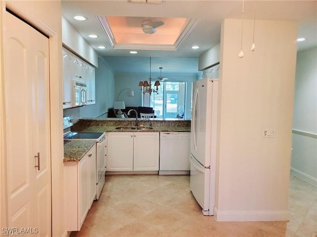 kitchen with white cabinetry, sink, hanging light fixtures, dark stone countertops, and white appliances