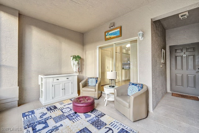 interior space with light tile patterned flooring and a textured ceiling