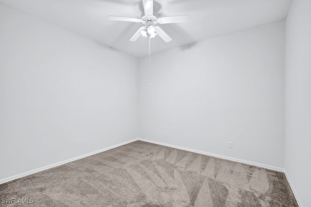 carpeted spare room featuring ceiling fan