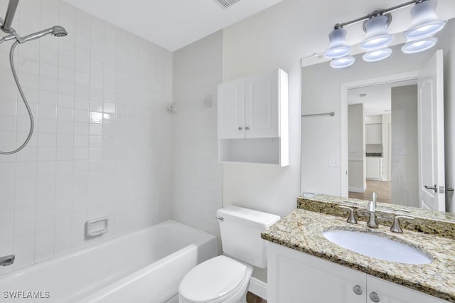 full bathroom with vanity, toilet, and tiled shower / bath