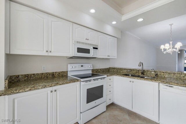 kitchen with white appliances, crown molding, sink, dark stone countertops, and white cabinetry