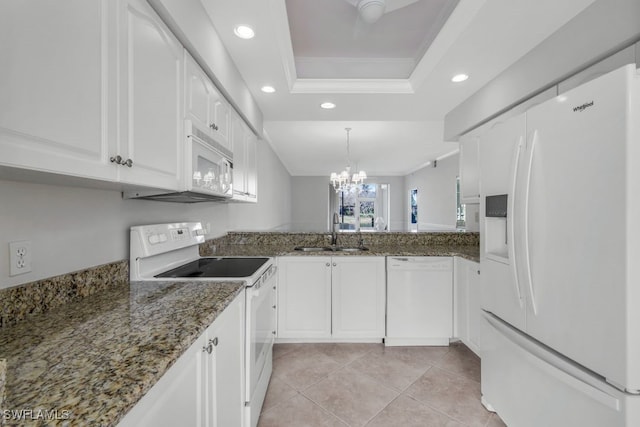 kitchen with white appliances, white cabinets, sink, dark stone countertops, and a notable chandelier