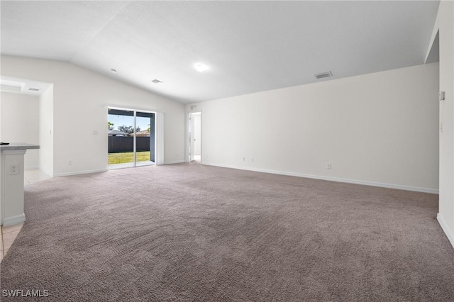 empty room featuring light colored carpet and lofted ceiling