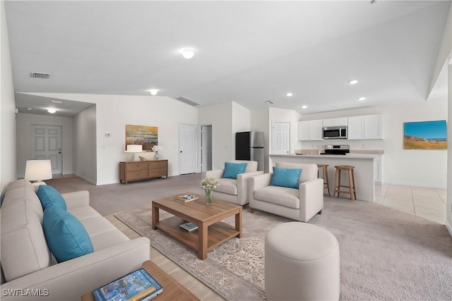 carpeted living room with lofted ceiling