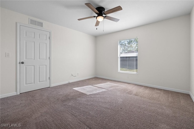 spare room with carpet and ceiling fan