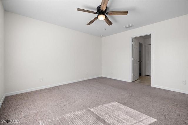 empty room featuring light colored carpet and ceiling fan