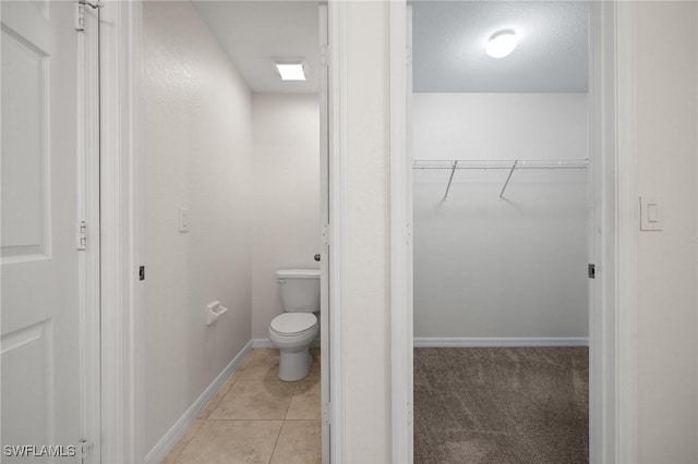 bathroom featuring tile patterned floors and toilet