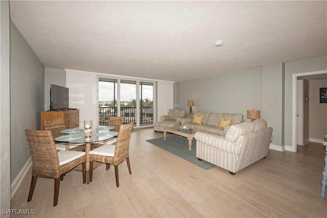 living room with light hardwood / wood-style flooring and a textured ceiling