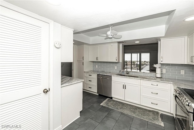 kitchen featuring stainless steel appliances, white cabinetry, and sink