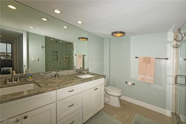 bathroom with toilet, vanity, tile patterned floors, and a shower with shower door