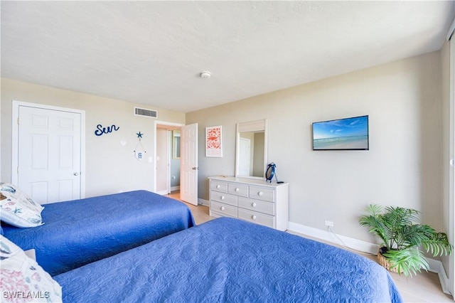 bedroom featuring visible vents and baseboards