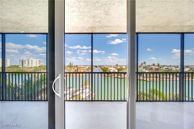 unfurnished sunroom with a water view and a wealth of natural light