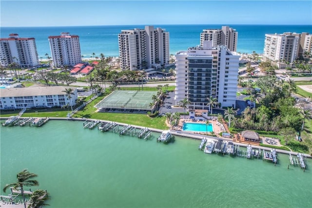 birds eye view of property with a view of city and a water view