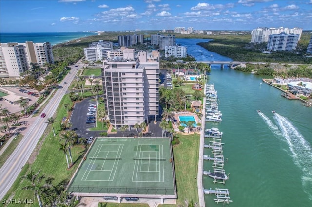 birds eye view of property with a water view and a city view