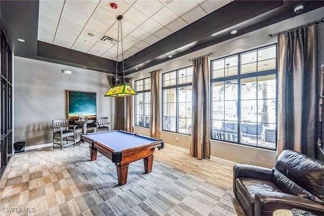 game room with a raised ceiling, plenty of natural light, light colored carpet, and pool table