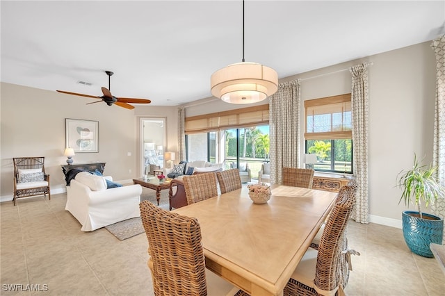 tiled dining area featuring ceiling fan