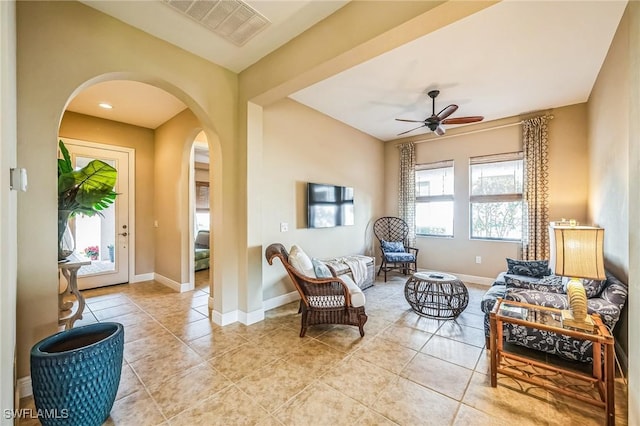 living area featuring ceiling fan and light tile patterned floors