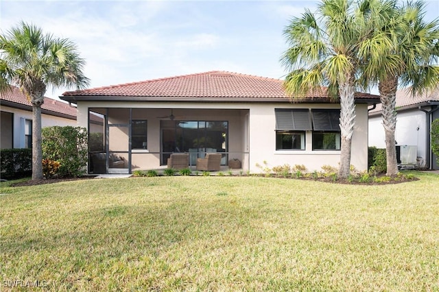 rear view of property with outdoor lounge area, a yard, and ceiling fan