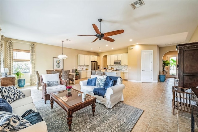 living room featuring ceiling fan, a healthy amount of sunlight, and light tile patterned flooring