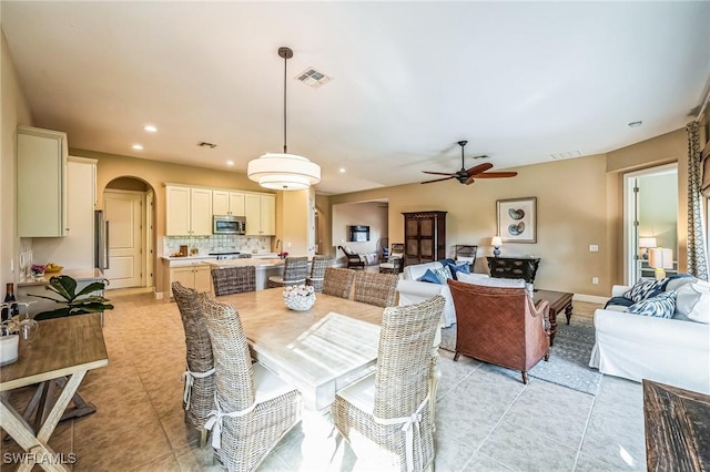 tiled dining room with ceiling fan