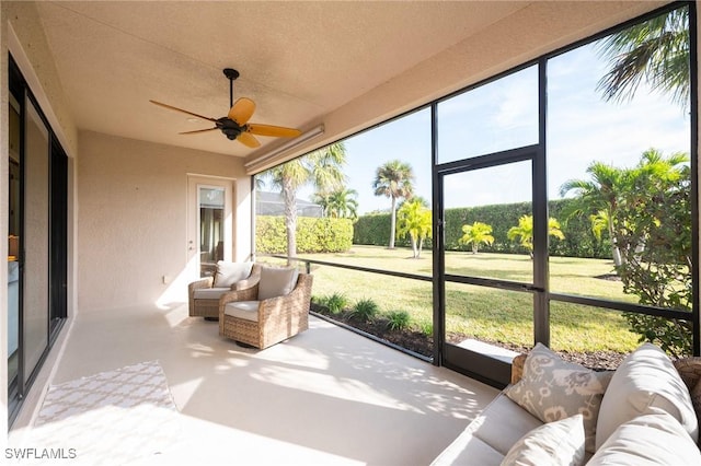 sunroom featuring ceiling fan