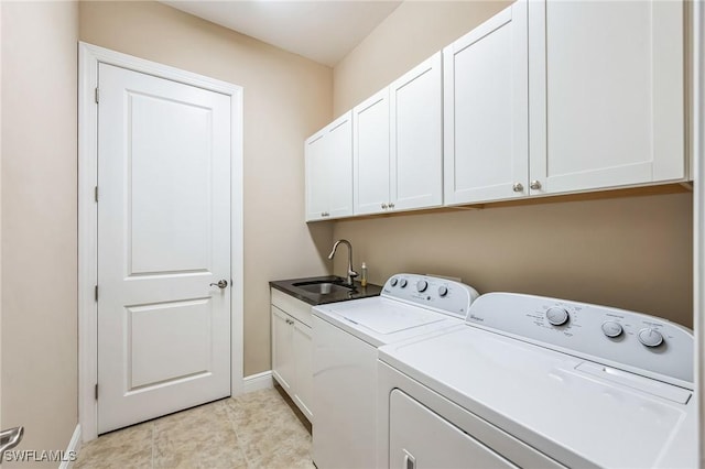 laundry area with washer and dryer, cabinets, and sink