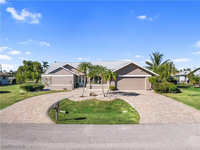 single story home featuring a front lawn and a garage