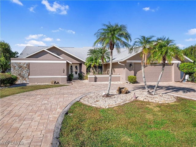 single story home featuring a garage and a front yard