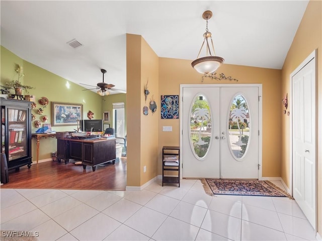 tiled foyer entrance featuring ceiling fan, lofted ceiling, and french doors