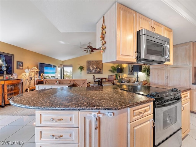 kitchen featuring kitchen peninsula, vaulted ceiling, light brown cabinets, and stainless steel appliances