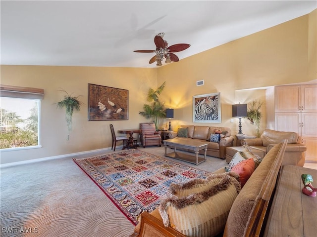 living room with vaulted ceiling, ceiling fan, and light colored carpet