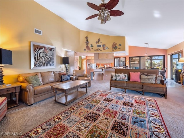 carpeted living room featuring ceiling fan and high vaulted ceiling