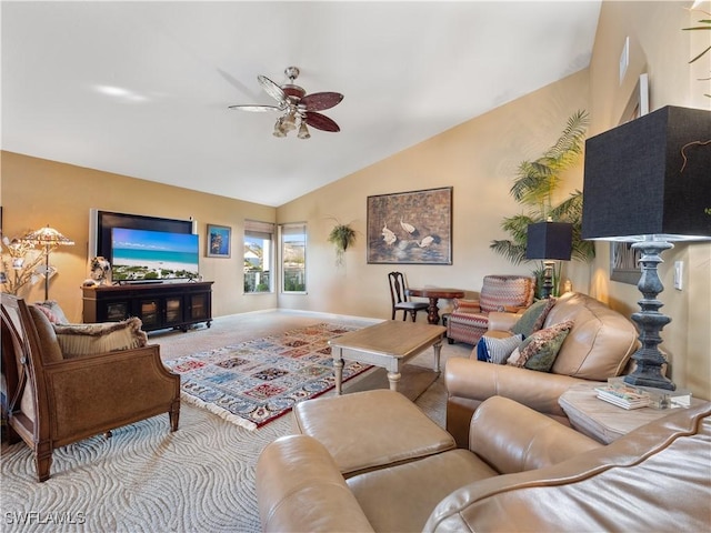 carpeted living room featuring ceiling fan and vaulted ceiling