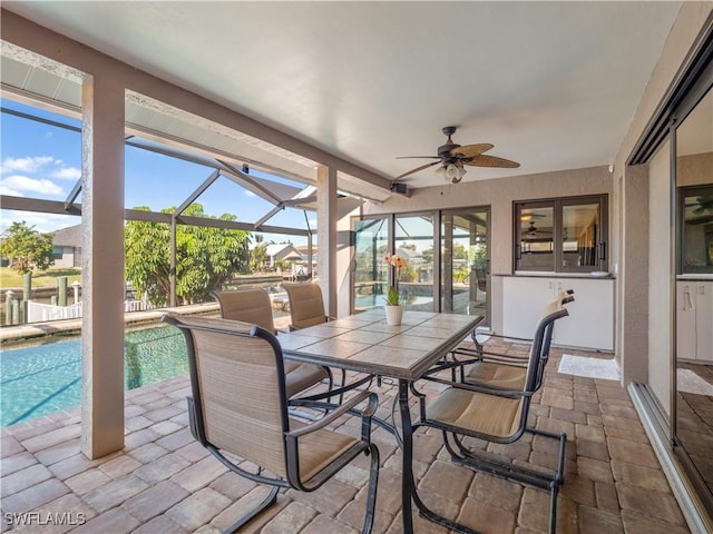 sunroom with ceiling fan and a pool