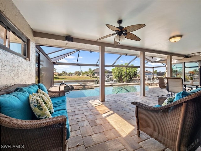 sunroom / solarium featuring ceiling fan, plenty of natural light, and a swimming pool