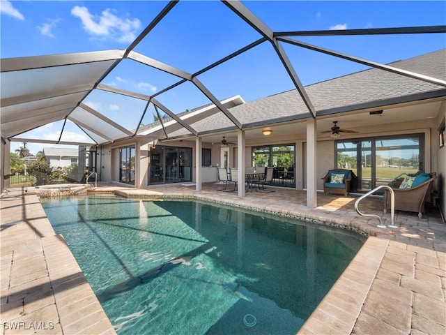 view of pool with ceiling fan, a patio, and a lanai